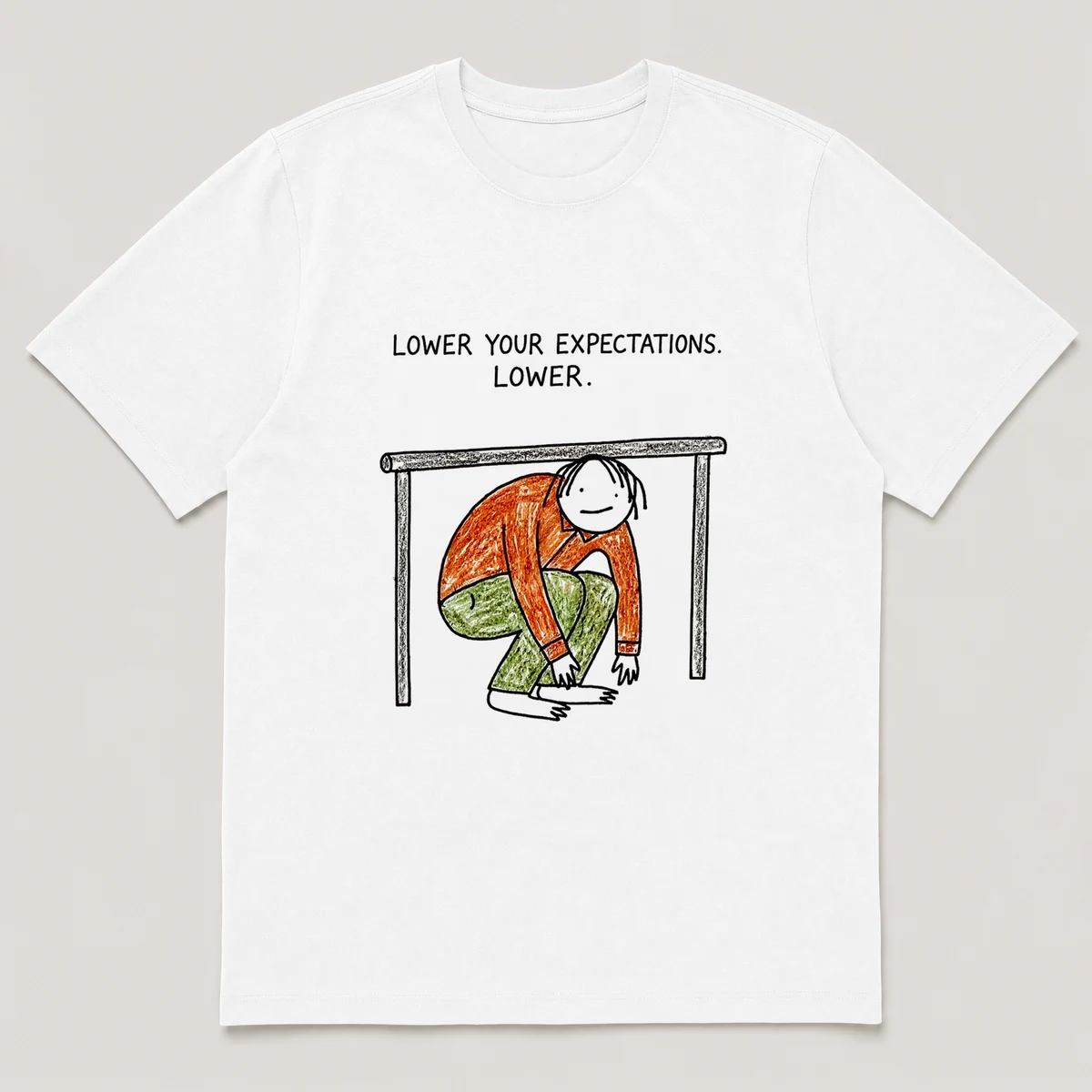 Front view of a White Tee printed with a guy crouches limbo-style under a bar that is almost touching the ground and the caption LOWER YOUR EXPECTATIONS. LOWER., White front view