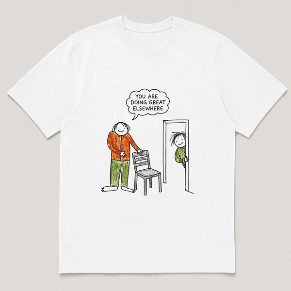 Front view of a White Tee printed with boss pats an empty chair while an employee watches from the doorway and the caption YOU ARE DOING GREAT ELSEWHERE