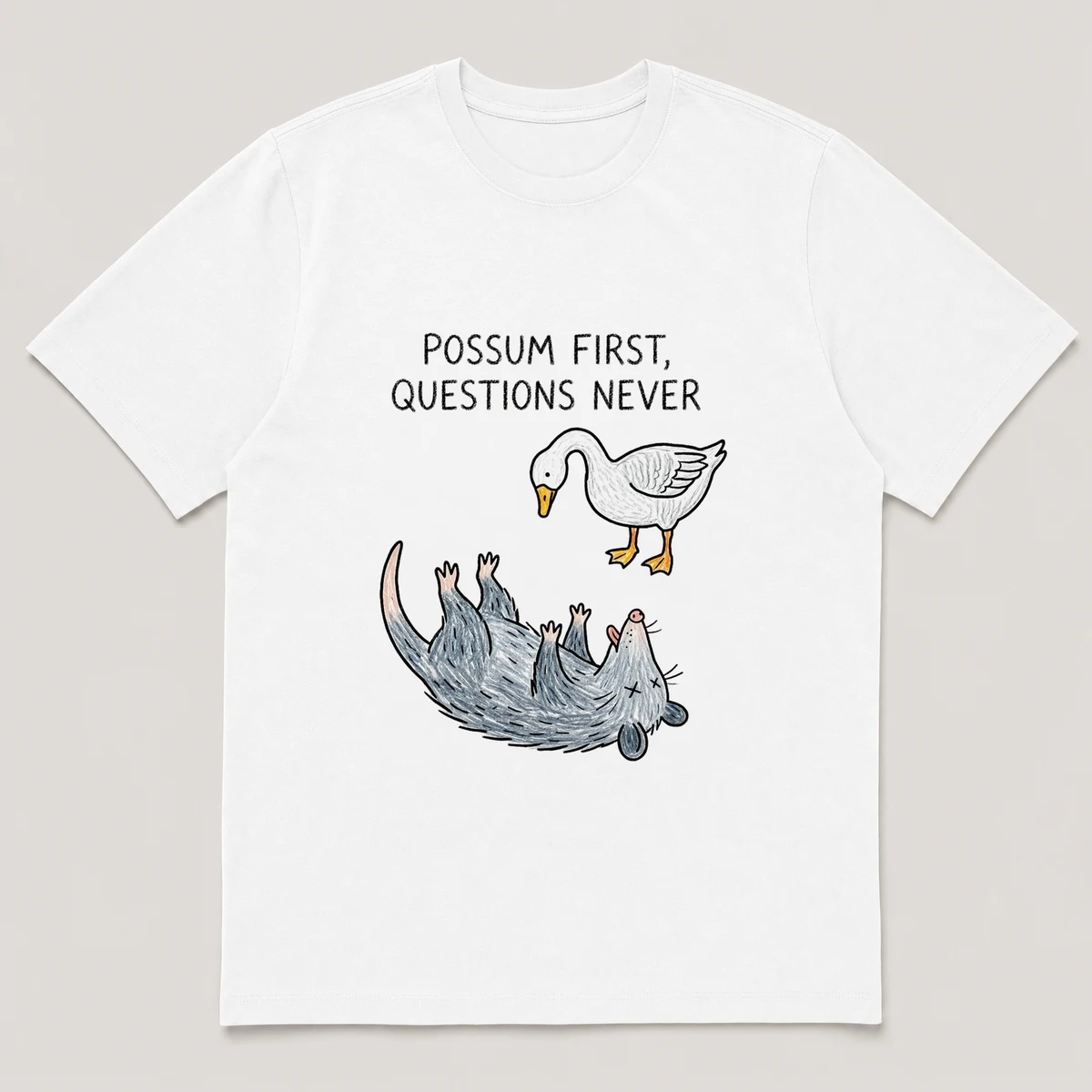 Front view of a White Tee printed with possum plays dead on its back while a goose stares down at it and the caption POSSUM FIRST, QUESTIONS NEVER, White front view