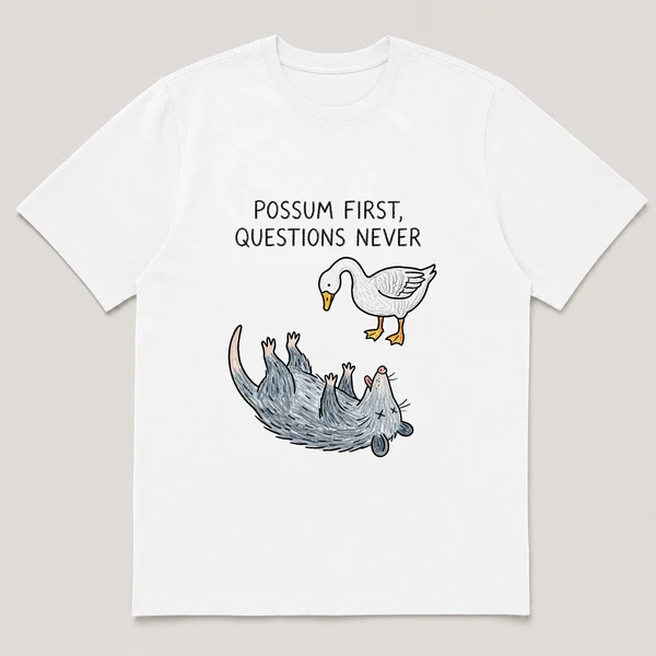 Front view of a White Tee printed with possum plays dead on its back while a goose stares down at it and the caption POSSUM FIRST, QUESTIONS NEVER