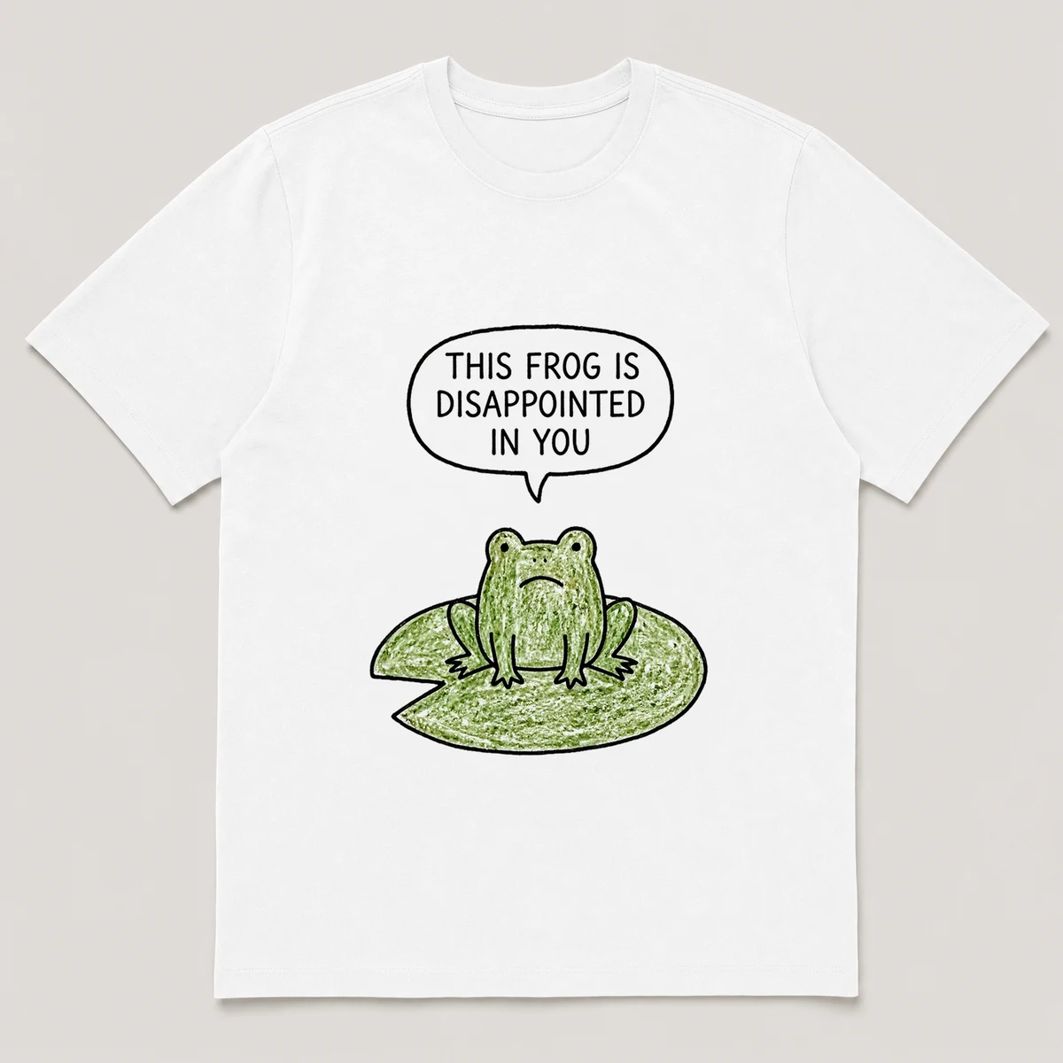 Front view of a White Tee printed with flat-faced frog stares straight at the viewer from a lily pad and the caption THIS FROG IS DISAPPOINTED IN YOU, White front view