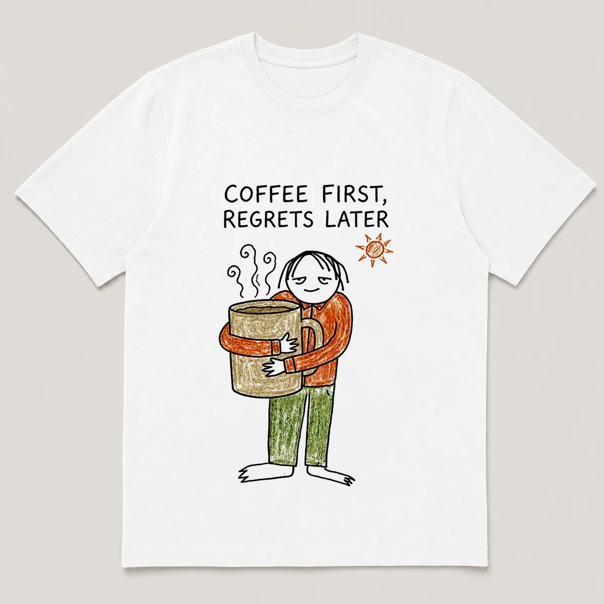 Front view of a White Tee printed with a bleary blob-headed guy hugs a giant steaming mug with both arms while the sun peeks in and the caption COFFEE FIRST, REGRETS LATER, White front view