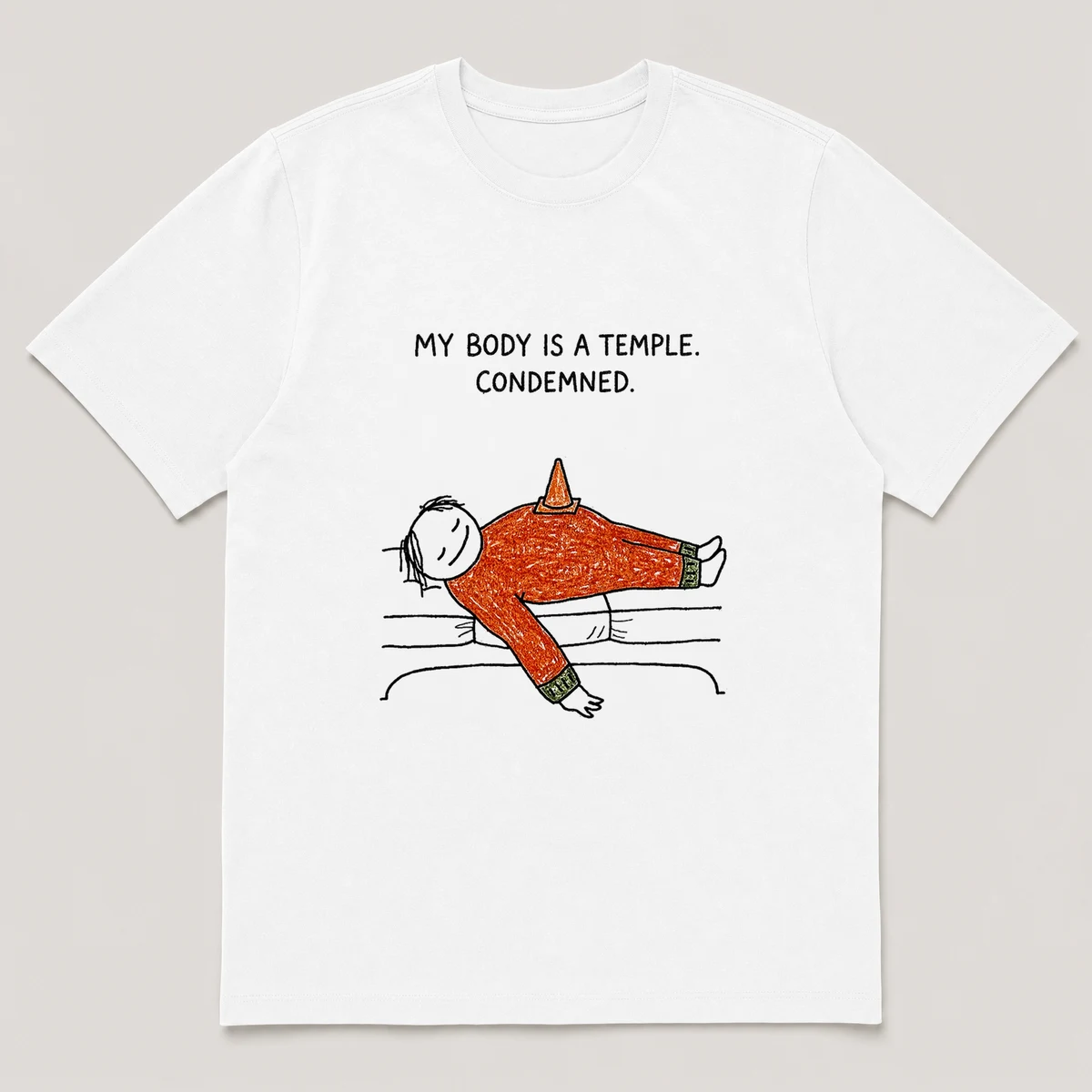 Front view of a White Tee printed with a guy lies flat on a couch with a small traffic cone balanced on his belly and the caption MY BODY IS A TEMPLE. CONDEMNED., White front view
