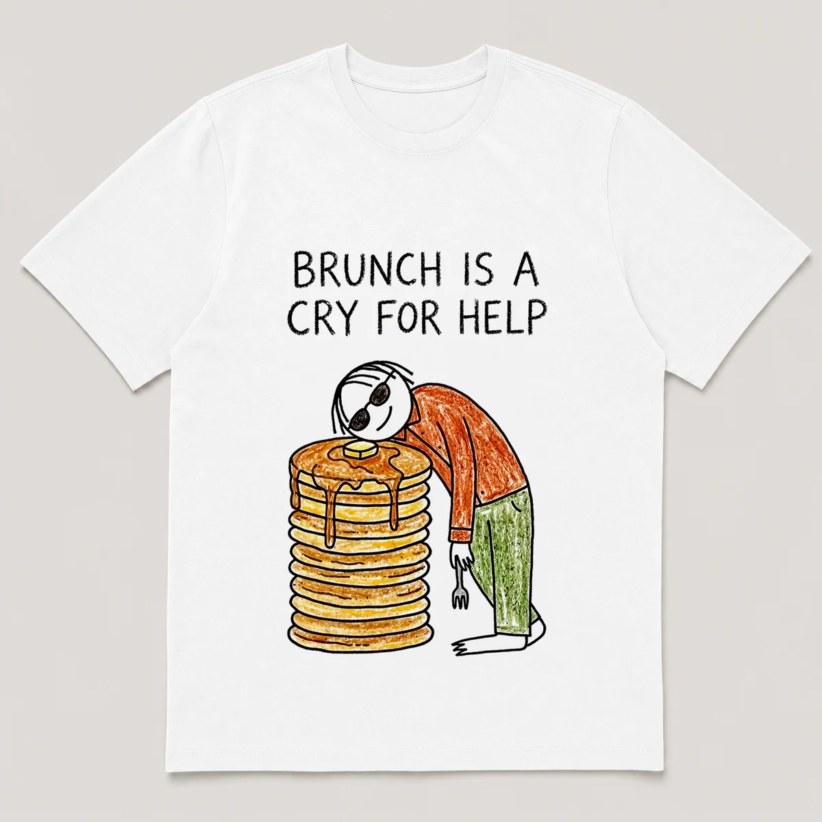 Front view of a White Tee printed with a guy in sunglasses slumps over a stack of pancakes taller than his head, fork drooping from one hand and the caption BRUNCH IS A CRY FOR HELP, White front view