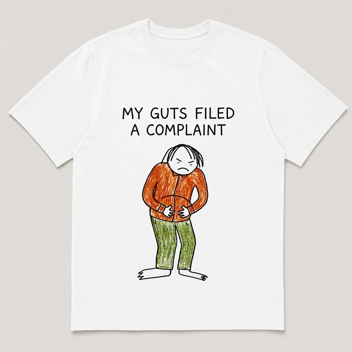 Front view of a White Tee printed with a guy clutches his stomach and glares down at his own belly and the caption MY GUTS FILED A COMPLAINT, White front view