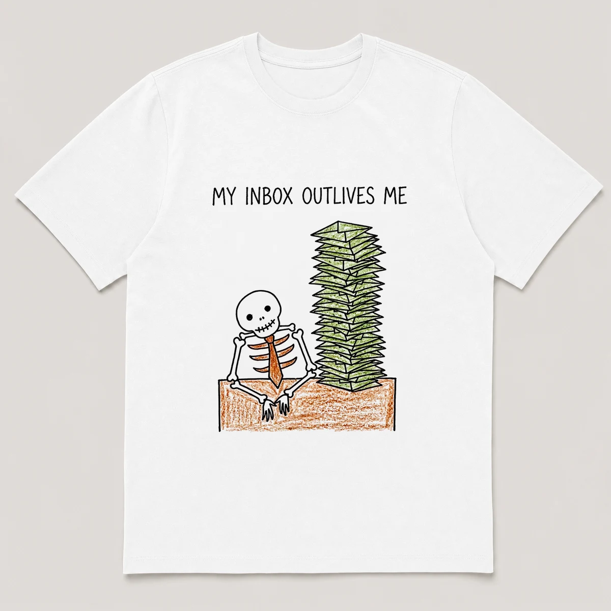 Front view of a White Tee printed with skeleton in a tie slumps at a desk buried under a tall stack of envelopes and the caption MY INBOX OUTLIVES ME, White front view